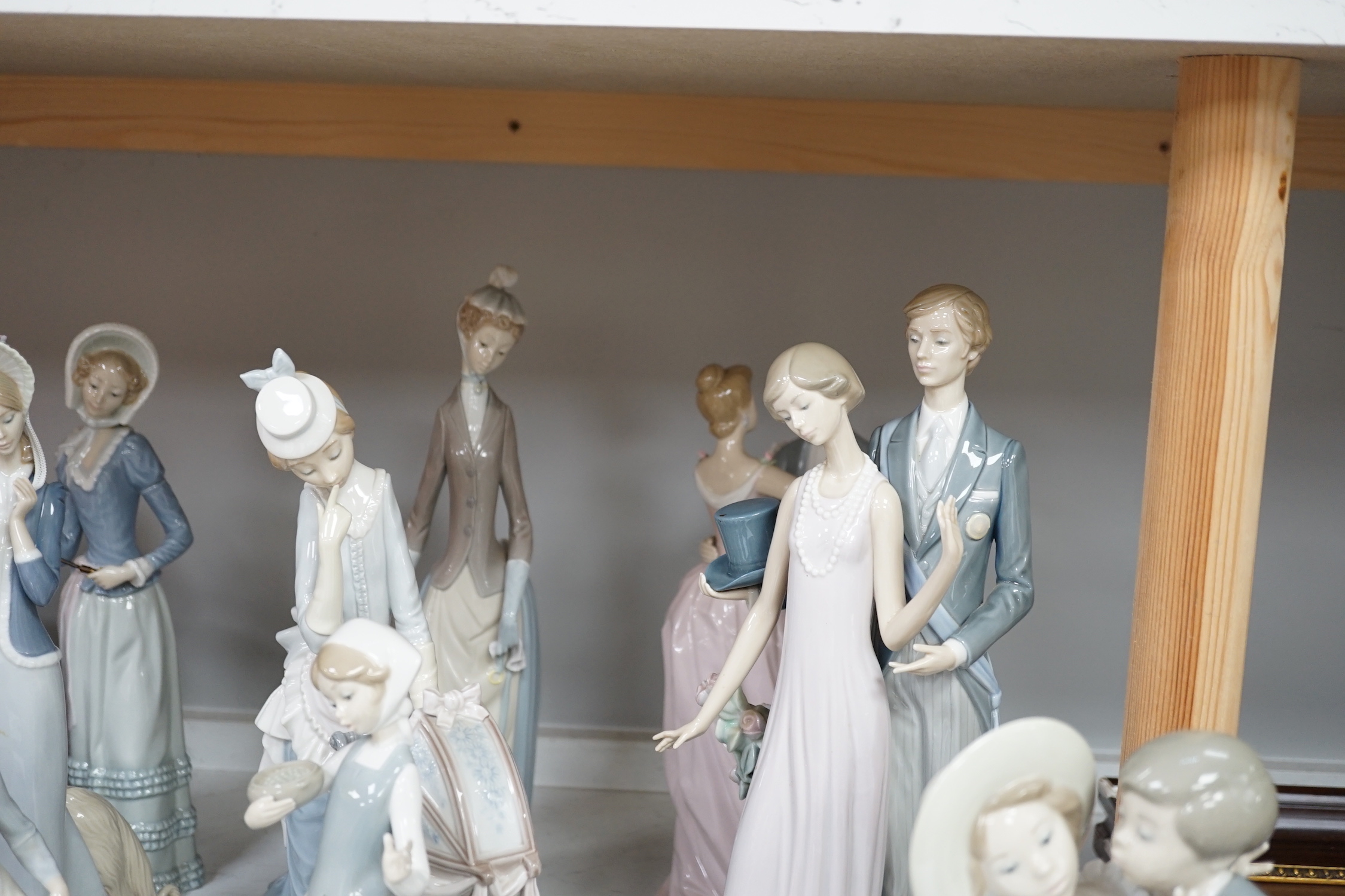 Collection of twelve Lladro figures including Precious Love and High Society